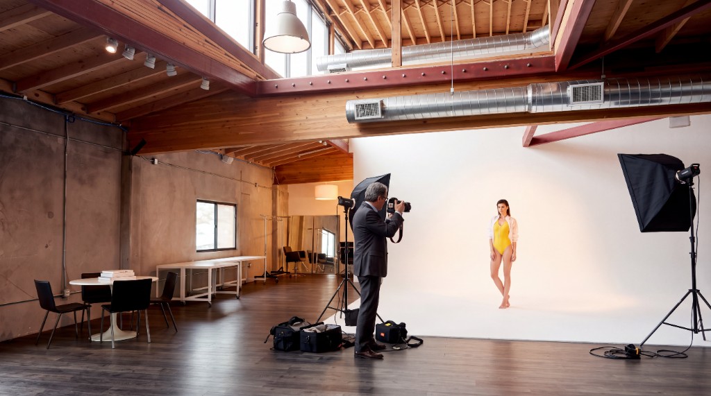 Egemen Mustafa Şener Studio — professional fashion photo shoot in progress, photographer and model on the cyclorama